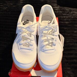 Nike White Sneakers with Black Swoosh and Gum Sole